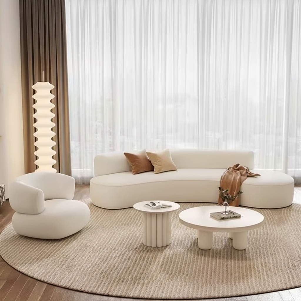 Modern living room with a white sofa, coffee table, and armchair.