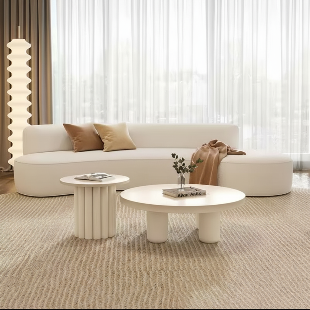 Living room with a white sofa, coffee table, and decorative items.