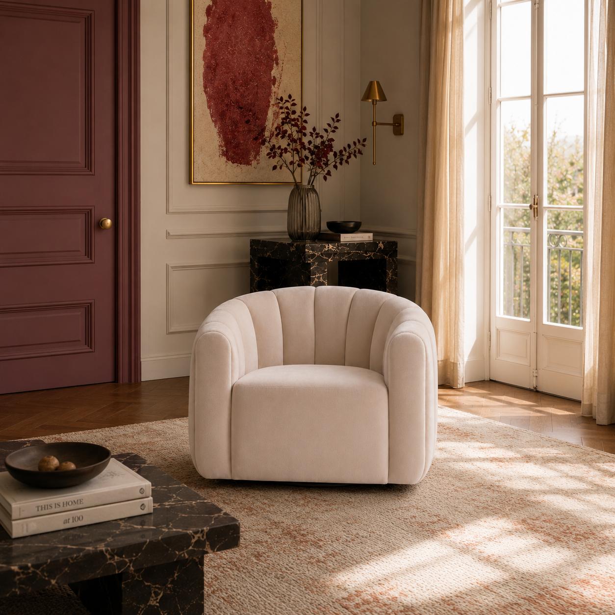 Luxury swivel armchair with a sculptural channelled design, available in ivory and cinnamon velvet upholstery.