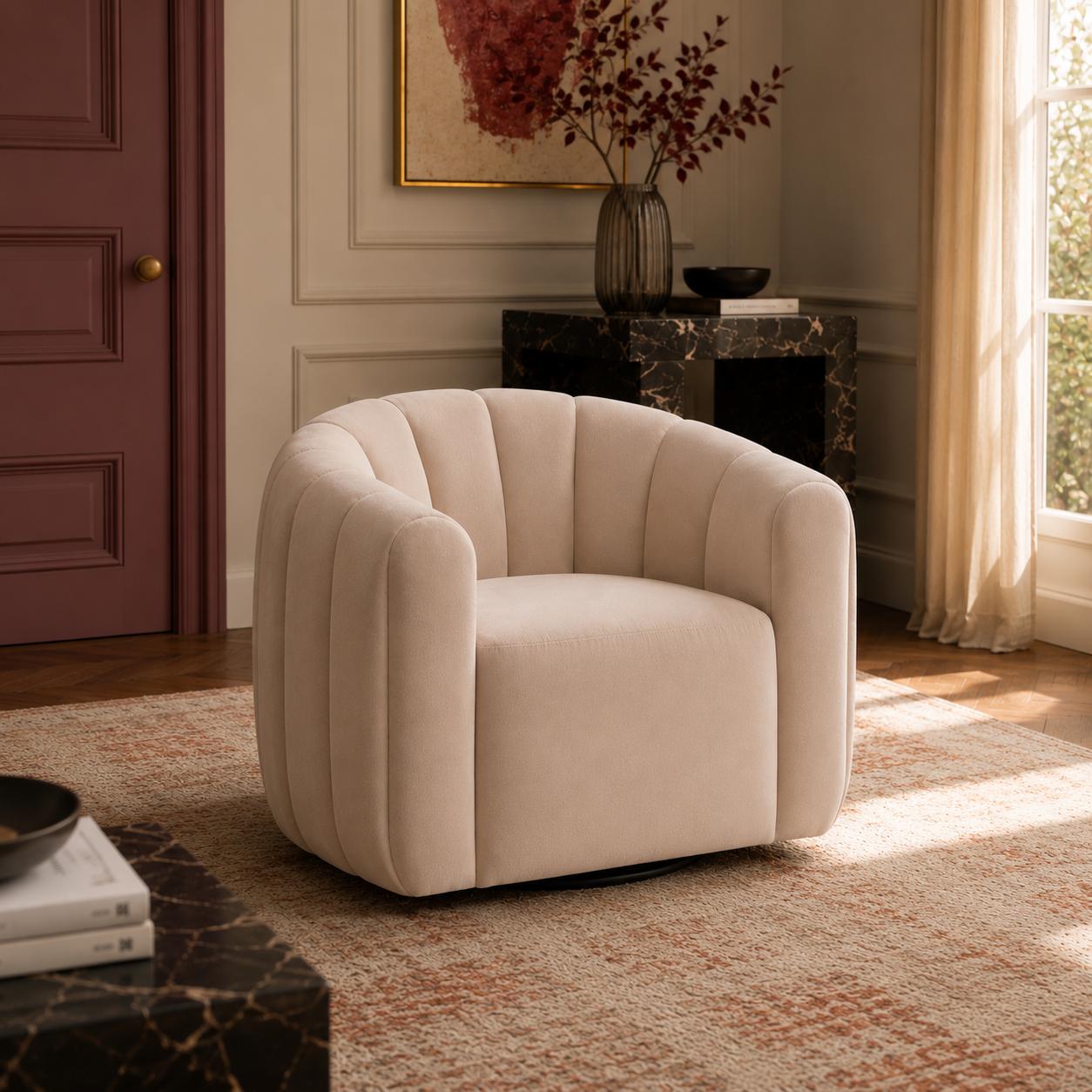 Luxury swivel armchair with a sculptural channelled design, available in ivory and cinnamon velvet upholstery.