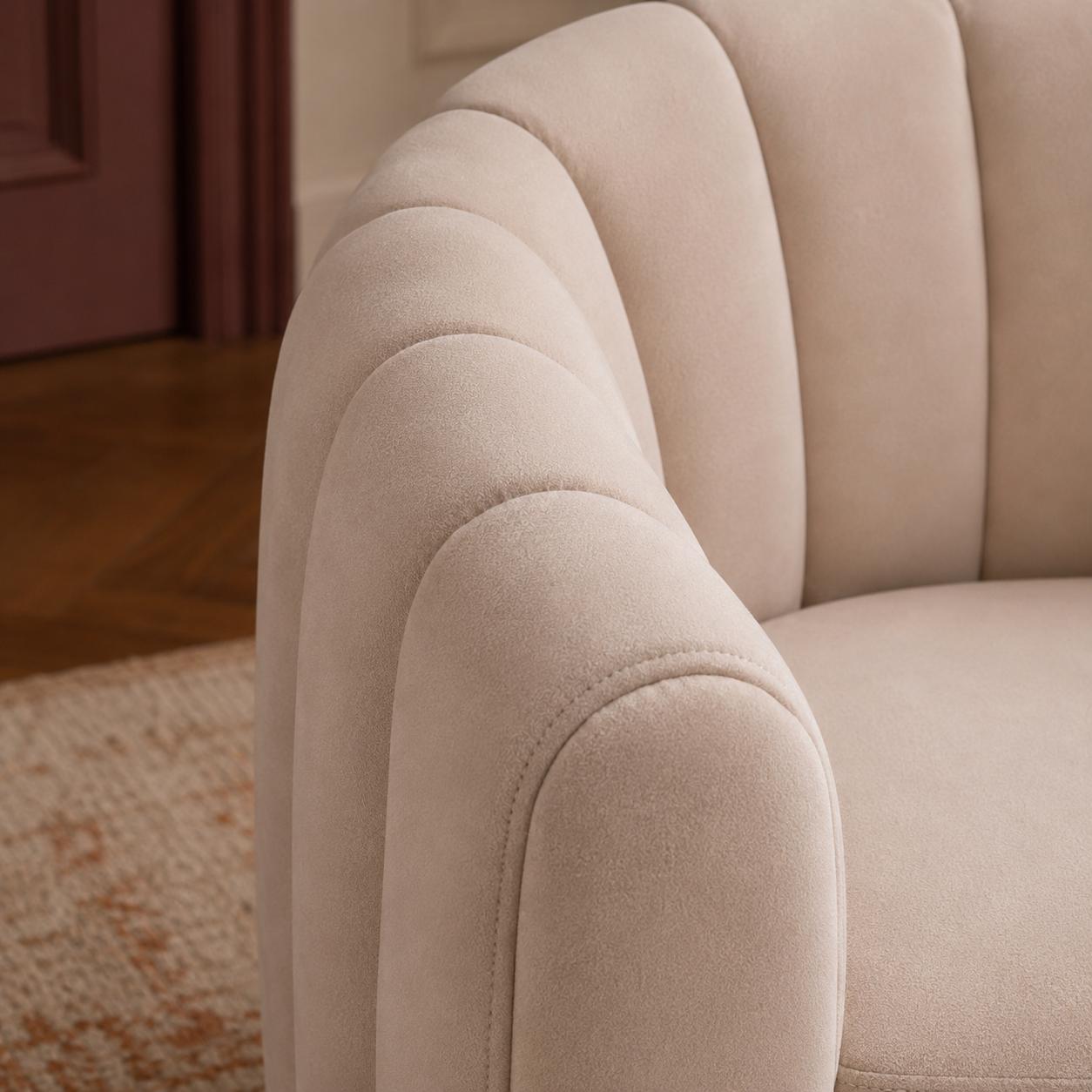 Luxury swivel armchair with a sculptural channelled design, available in ivory and cinnamon velvet upholstery.