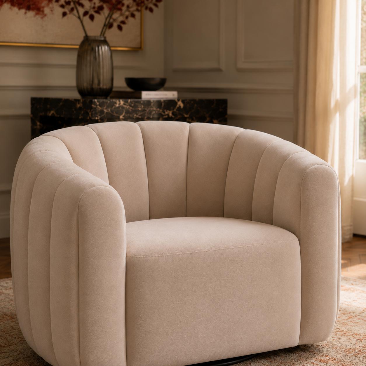  Luxury swivel armchair with a sculptural channelled design, available in ivory and cinnamon velvet upholstery.