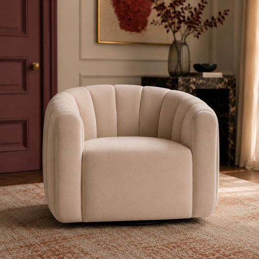 Luxury swivel armchair with a sculptural channelled design, available in ivory and cinnamon velvet upholstery.