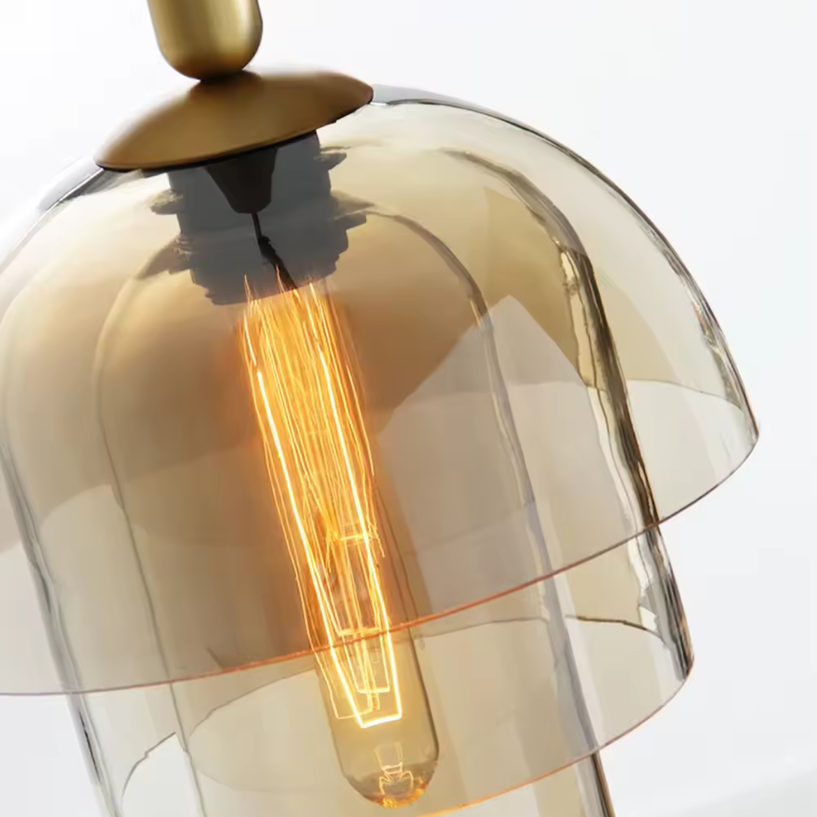 Glass lamp with a visible light bulb inside, on a white background