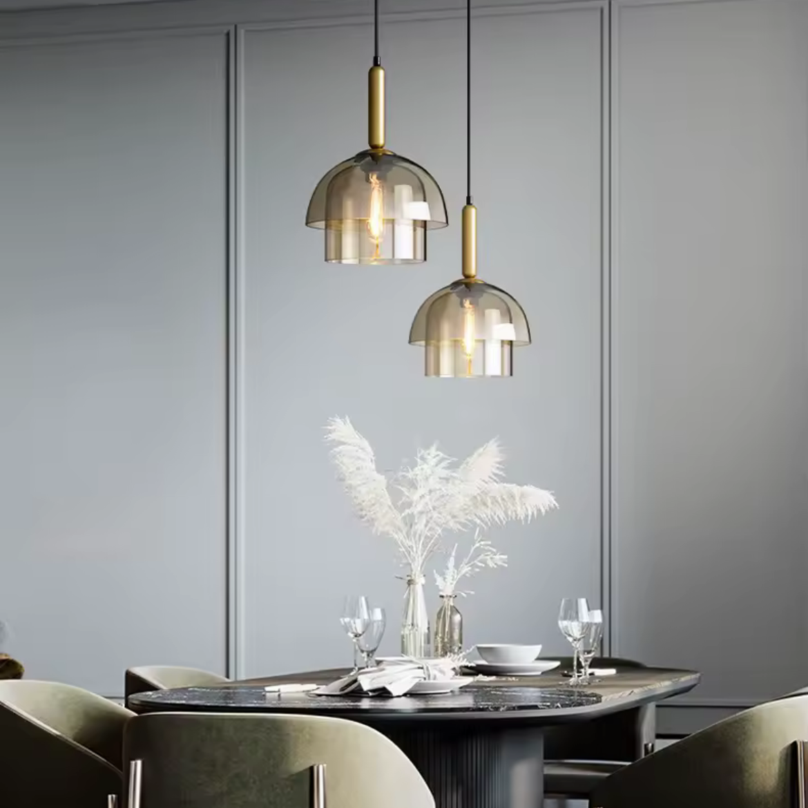Dining room with modern pendant lights, table setting, and gray walls.