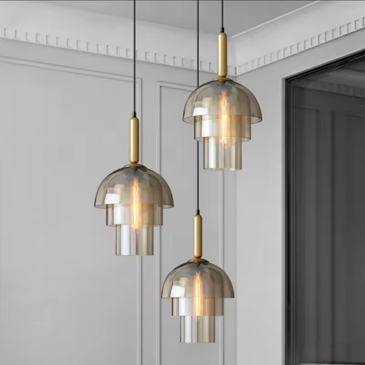 Modern pendant lights hanging in a room with a neutral color scheme.