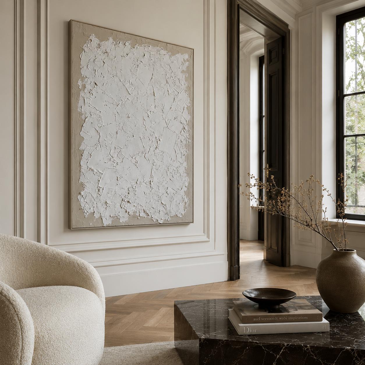 Modern interior with abstract art on the wall, a chair, and a vase on a table.