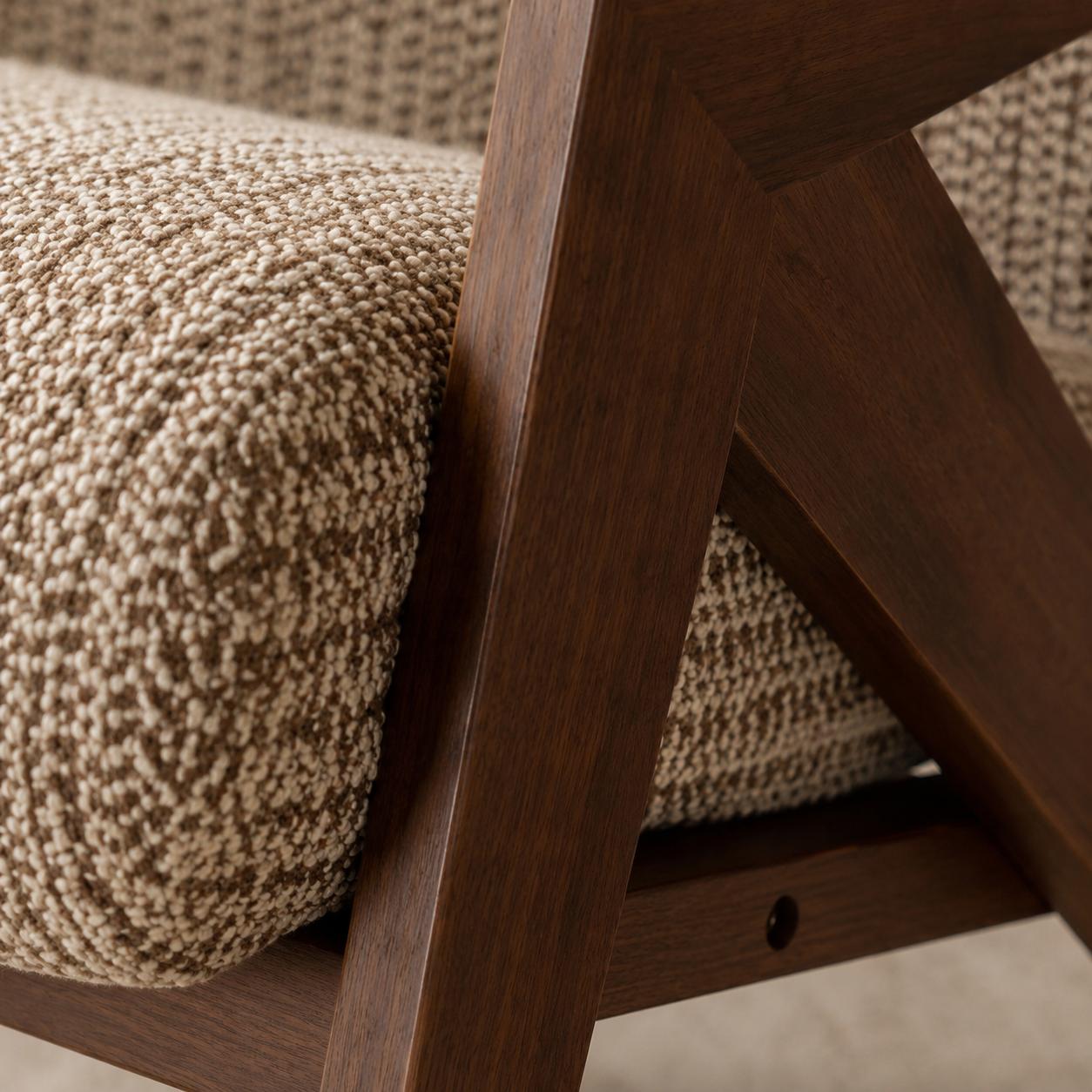 Contemporary armchair with premium woven fabric upholstery and a walnut finished wood frame in a luxury living room.