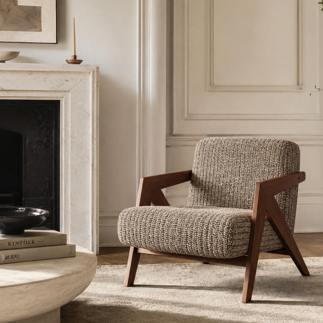 Contemporary armchair with premium woven fabric upholstery and a walnut finished wood frame in a luxury living room.