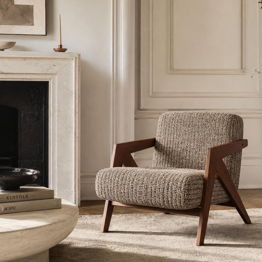 Contemporary armchair with premium woven fabric upholstery and a walnut finished wood frame in a luxury living room.